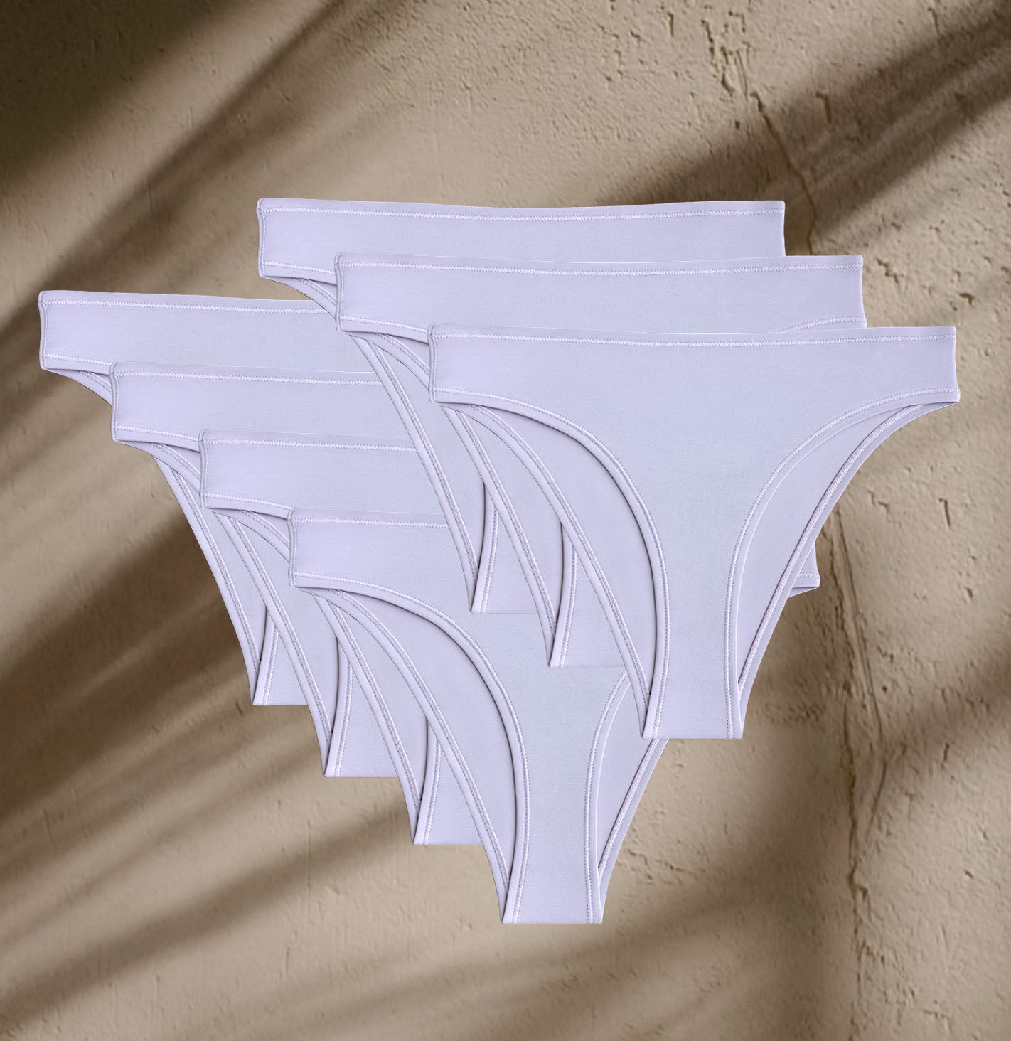 Seven pairs of Kiseau Organic Cotton Brazilian Underwear, small-batch sustainable collection crafted from toxin-free fibers.