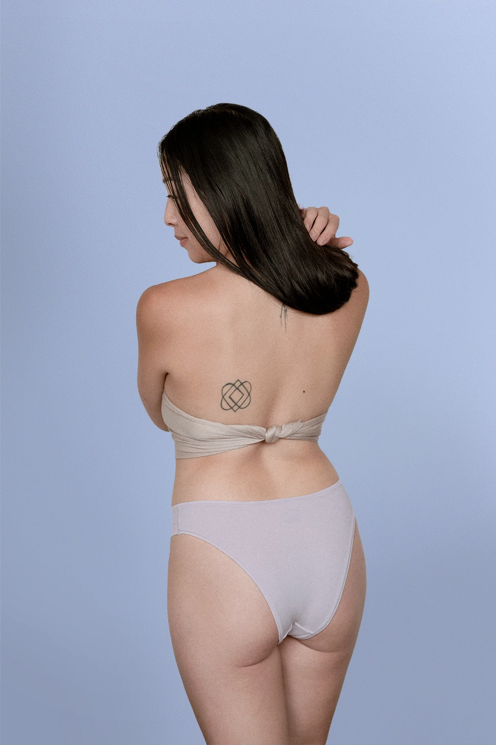 Woman wearing Kiseau organic cotton Brazilian underwear for women, breathable sustainable fabric, back view.