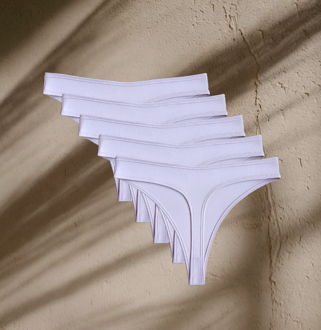 Five pairs of Kiseau Organic Cotton Thong Underwear in natural hue, breathable and toxin-free minimalist essentials.
