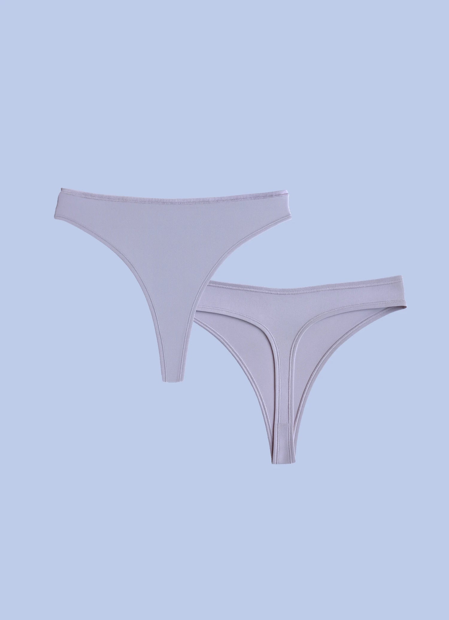 Kiseau organic cotton thong underwear for women, breathable sustainable fabric, front and back flat lay.