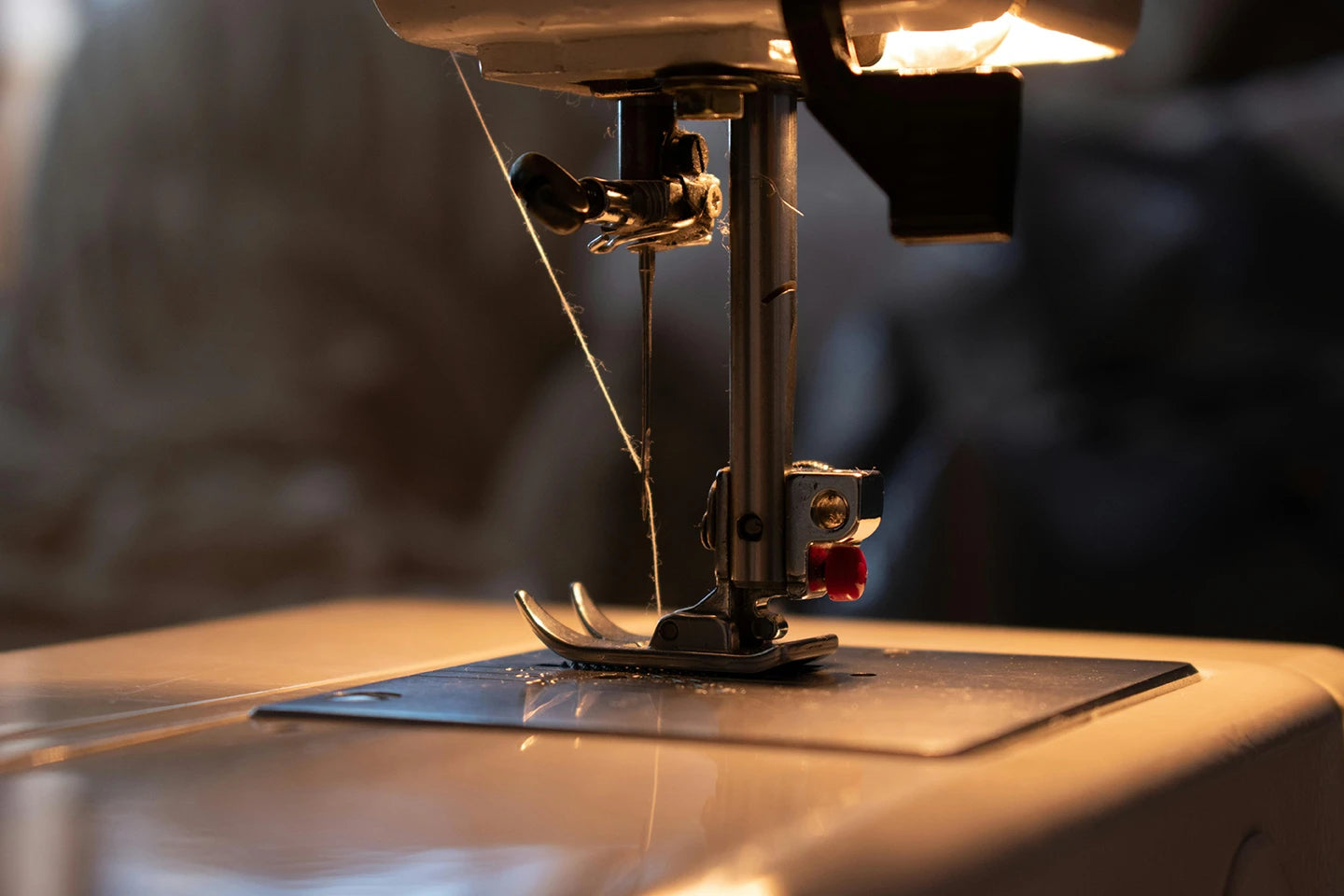 Close-up of a sewing machine needle and sustainable toxin free thread
