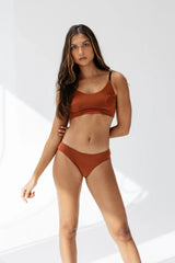 Model wearing Kiseau Terracotta Cheeky Bikini and Bralette, seaweed organic cotton