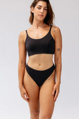 Model wearing Kiseau Charcoal Classic Thong and Bralette, front view