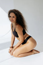 Kiseau Charcoal Classic Thong and Bralette kneeling view — toxin-free seaweed organic cotton lingerie set