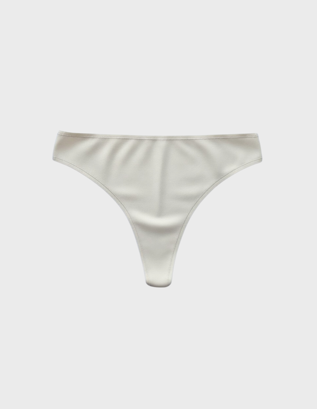 Kiseau classic thong underwear in natural undyed beige — sustainable women's underwear made from Icelandic seaweed-infused organic cotton, flat lay front view