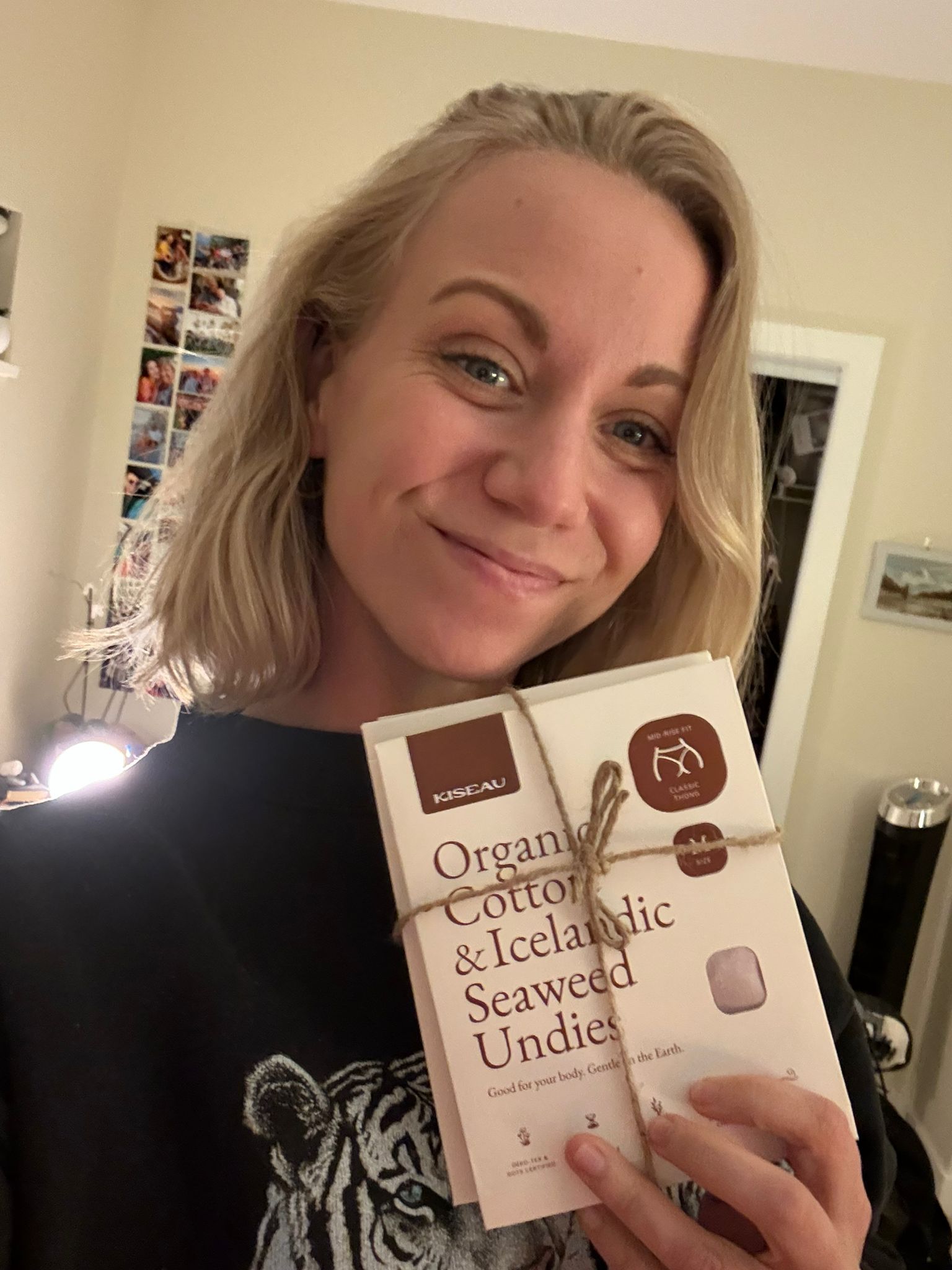 Happy customer holding Kiseau Organic Cotton & Icelandic Seaweed Undies packaging, sharing positive feedback on comfort and quality.