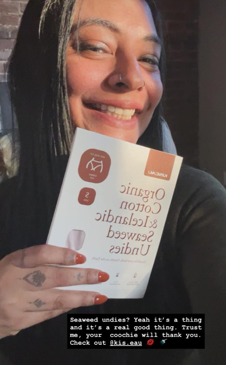 Customer smiling while holding Kiseau Organic Cotton & Icelandic Seaweed Undies box, sharing an enthusiastic testimonial about comfort and breathability.