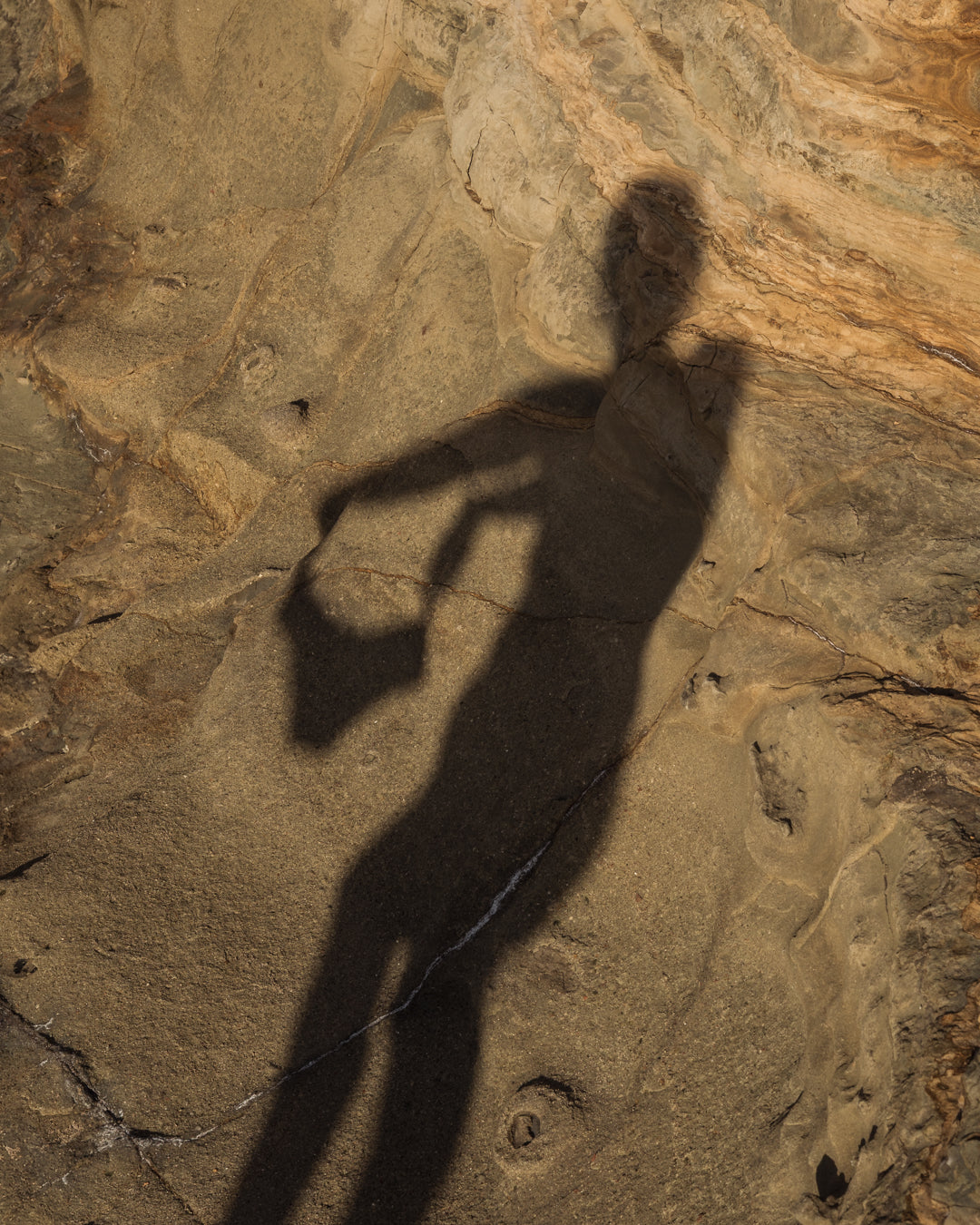 Soft silhouette of a woman’s shadow cast on natural stone, evoking slow living, body awareness, and Kiseau’s philosophy of natural, non-toxic intimate wear.