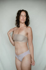 Kiseau organic cotton bikini underwear for women, eco-friendly breathable fabric, model side front pose.