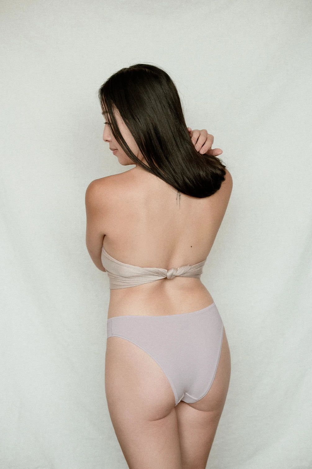 Woman wearing Kiseau organic cotton Brazilian underwear for women, breathable sustainable fabric, back view.