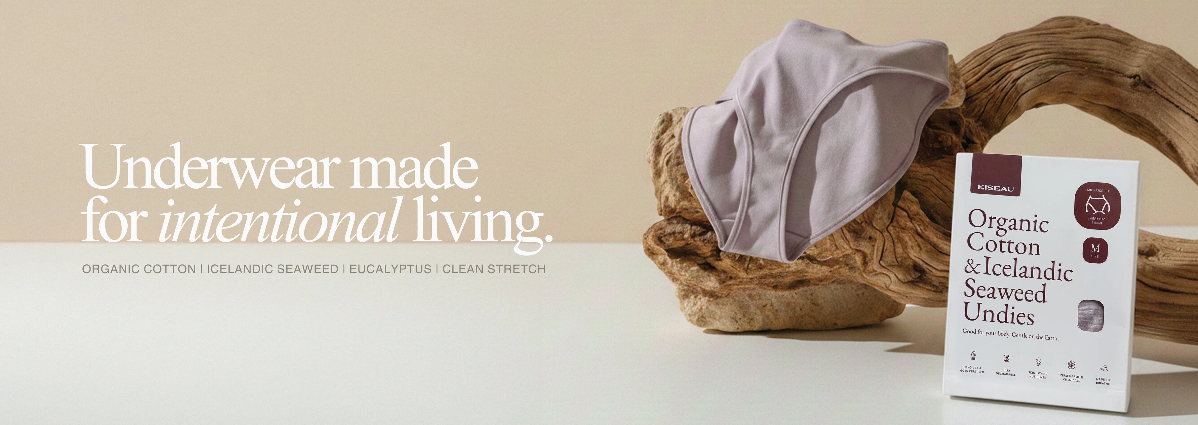 Kiseau organic cotton and Icelandic seaweed underwear displayed on natural wood beside sustainable packaging, representing intentional living and toxin-free comfort.