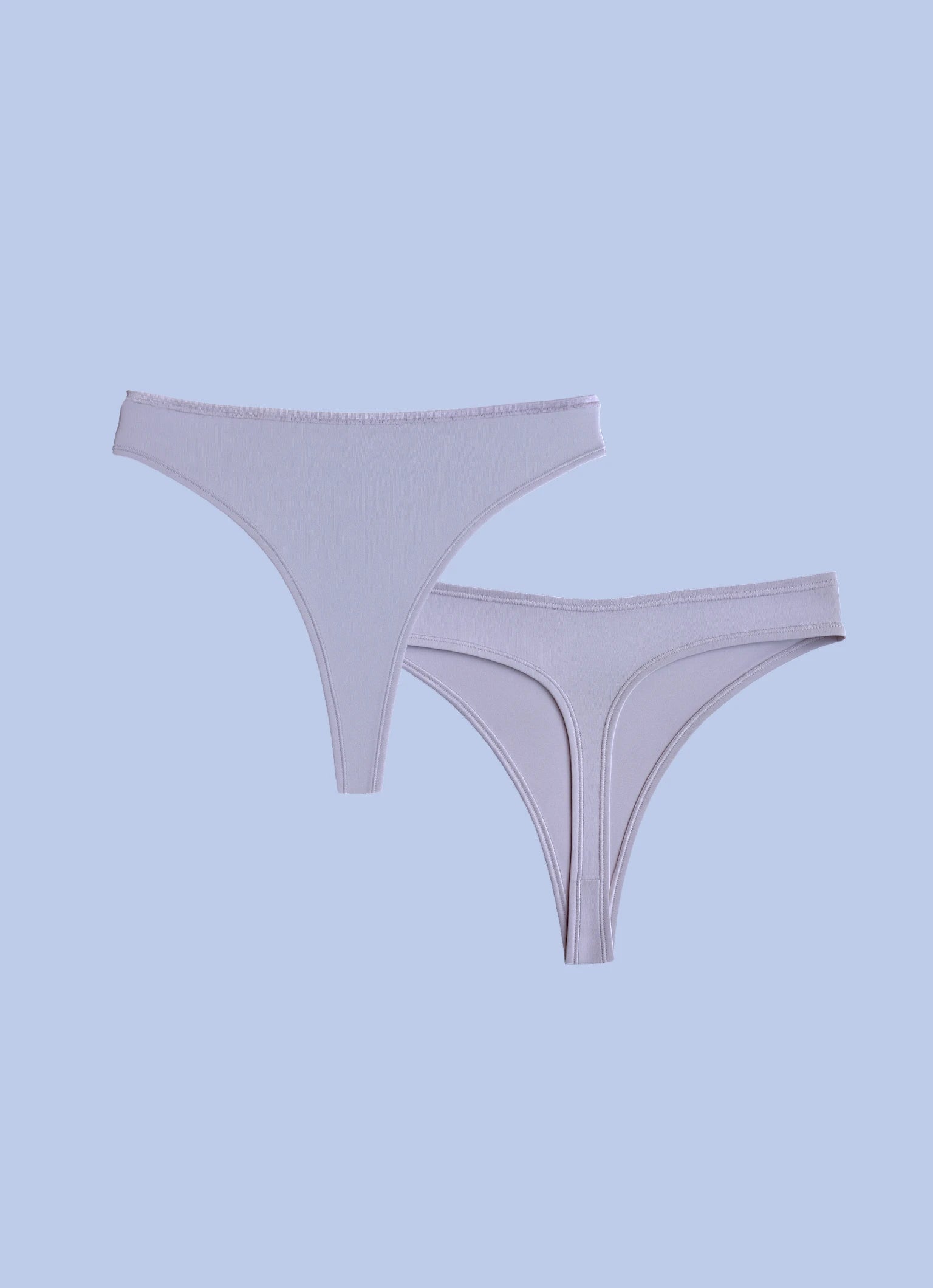 Kiseau organic cotton thong underwear for women, breathable sustainable fabric, front and back flat lay.