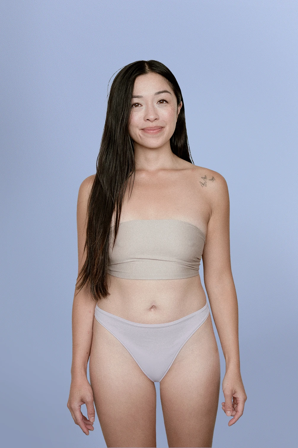 Woman wearing Kiseau organic cotton thong underwear for women, eco-friendly breathable design, front view.