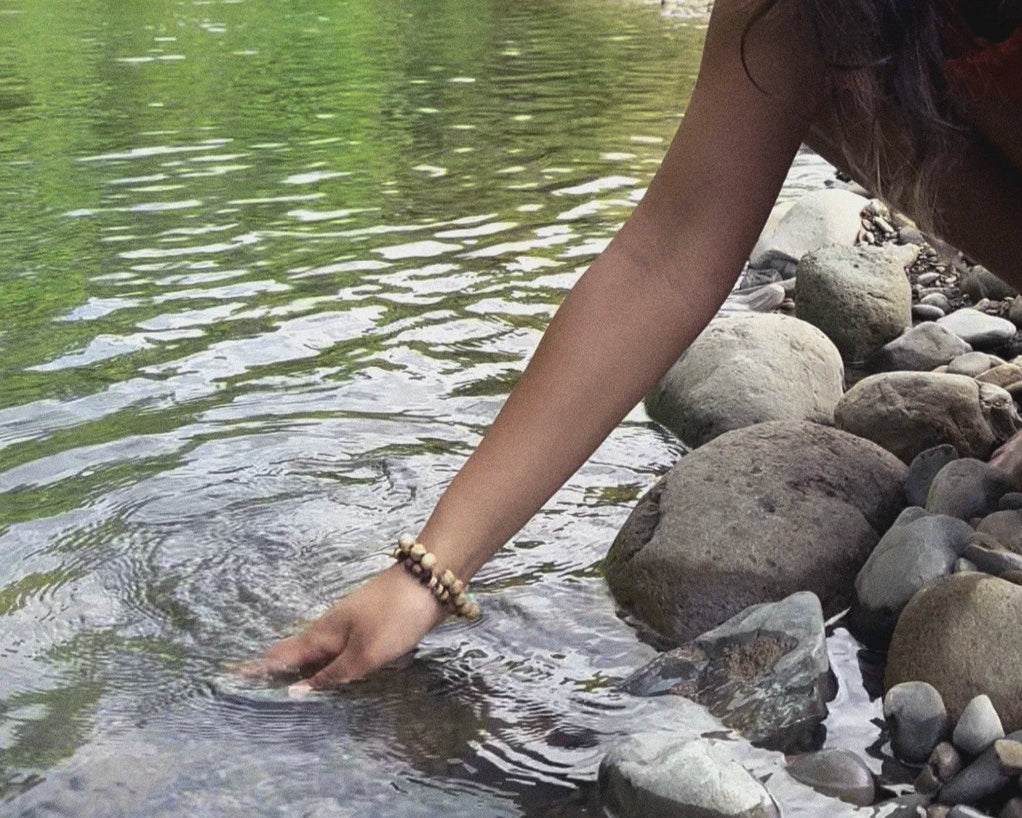 Woman founder being sea-kissed by water 
