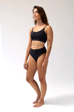 Model wearing Kiseau Charcoal Bralette and High Waist Brief, front view