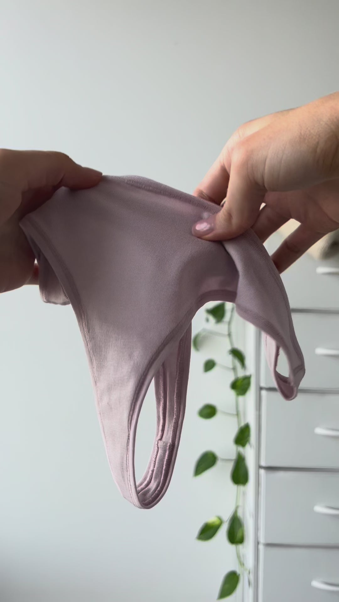 Hands stretching a pair of Kiseau organic cotton and Icelandic seaweed underwear to show the lightweight, soft, and elastic-free fabric.